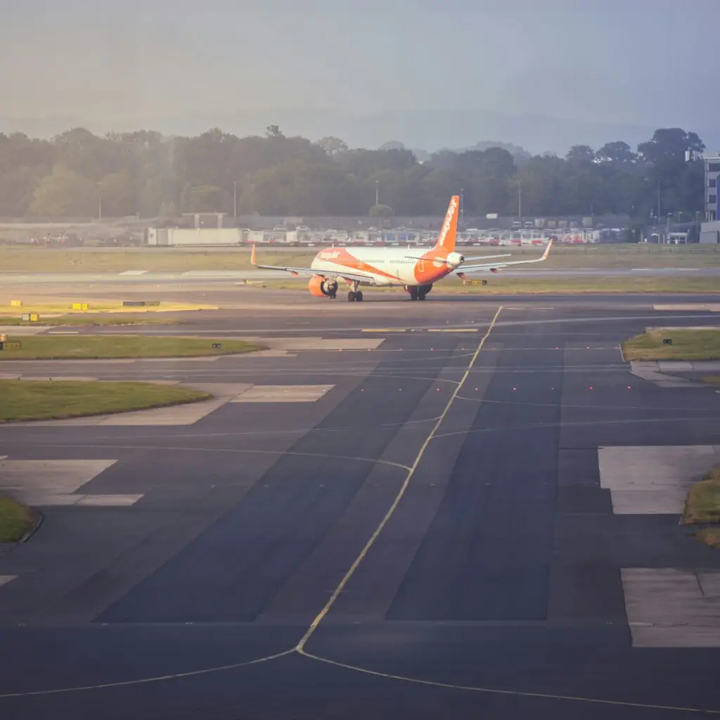 Easyjet plane on the tarmac making a turn at the end of a runway at Gatwick Airport