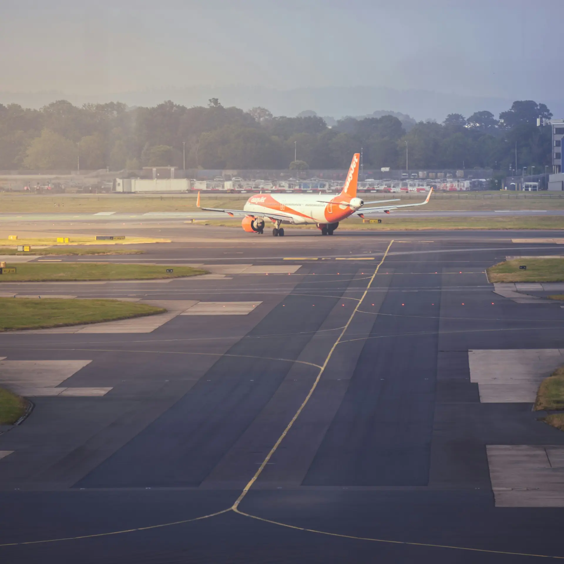 Easyjet plane on the tarmac making a turn at the end of a runway at Gatwick Airport